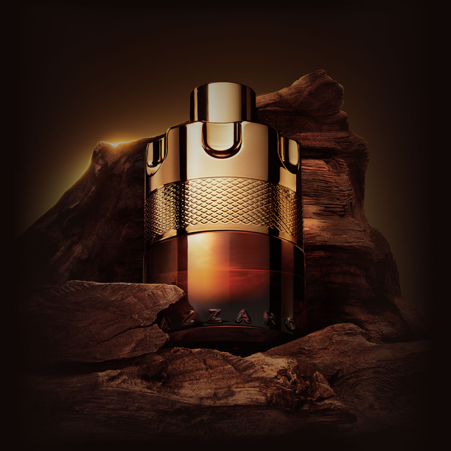 Azzaro Wanted bottle on a rocky terrain lit by a warm glow